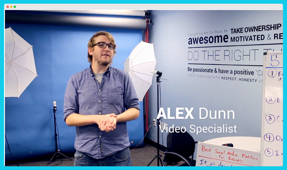 A man standing in a video studio with the lower-thirds text, 'Alex Dunn, Video Specialist'