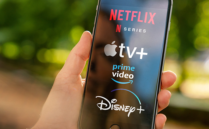 Mobile Phone With OTT Streaming Services Logos Including Netflix, Apple Plus, Prime, and Disney Plus