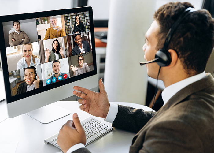 Employee on a video conference with several other participants.
