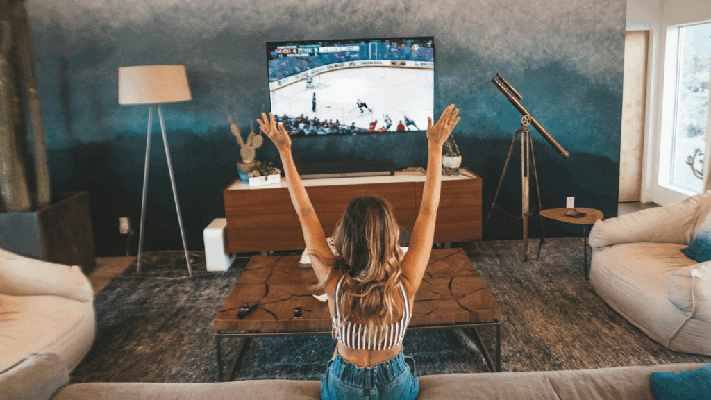 Woman streaming hockey on a TV